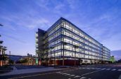 View of the 6-storey modern building at the Grand Central Creative Campus at dusk